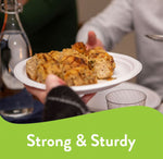 Hands passing a Chinet disposable plate topped with breaded rolls at a dining table, labeled strong and sturdy