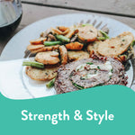 Close-up of a plated meal on a clear Chinet Crystal dinner plate showing steak and seasoned potato slices outdoors.