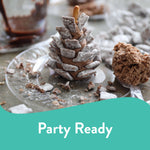 Close-up of a clear Chinet plate holding a chocolate dessert and scattered crumbs, promotional ‘Party Ready’ banner