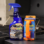 Citrusafe BBQ Grill Cleaner bottle paired with boxed orange-handled scrubber placed near a grill.