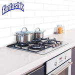 Clean modern kitchen stovetop and countertop scene with pots and a Fantastik logo in the corner