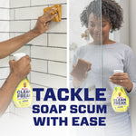 Two-panel photo of hands cleaning shower tile and glass with a Mr. Clean Clean Freak lemon zest spray bottle and cloths.