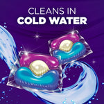 Illustration of two detergent paks with water swirls and bold text 'Cleans in cold water' on purple background