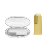 Clear oval storage case open with gray toothbrush inside and a yellow silicone finger toothbrush beside it