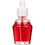 Close-up front view of a clear glass fragrance oil refill bottle filled with red amber and saffron oil