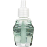 Close-up studio shot of a clear glass fragrance oil refill bottle filled with pale green liquid and a white plastic cap
