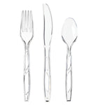 Three clear plastic utensils - fork, serrated knife and spoon - photographed on a white background