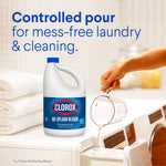 Clorox No-Splash Bleach jug beside a hand pouring liquid into a washing machine compartment, 'Controlled pour' text