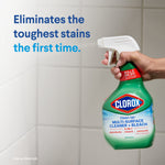 Hand holding a Clorox Clean-Up spray bottle against tiled wall with headline 'Eliminates the toughest stains the first time.'