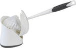 Toilet brush being placed into a white hideaway holder showing the brush shield and holder interior