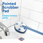 Clorox extendable scrubber with pointed blue pad cleaning a bathtub corner, labeled ‘Pointed Scrubber Pad’