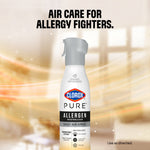 Clorox PURE allergen neutralizer spray bottle centered against a warm blurred interior background with headline about air care