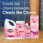Bathroom scene with multiple pink Clorox Scentiva cleaning products and packaging against tiled wall