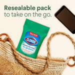 Lifestyle image of a resealable Clorox to-go wipes pack tucked inside a woven bag next to a smartphone