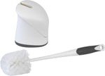 White toilet bowl brush with black-grip handle separated from a white rounded holder on a white background