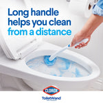 Person using a Clorox ToiletWand to scrub inside a toilet bowl with blue cleaning foam