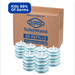 Cardboard box labeled Clorox ToiletWand with several stacked blue-and-white round scrubbing refill pads arranged in front