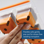 Close-up of fingers popping out an orange flexible SuperSeed cell through a clear tray lid, with an inset text panel about popping cells out