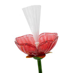 Close-up of red translucent flower head with white fiber-optic bundle rising from the center on a white background