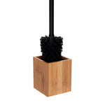 Close-up of black bristle head inserted into a square bamboo toilet brush holder on white background