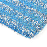 Close-up macro view of a blue metallic woven scrub pad showing silver strands and texture