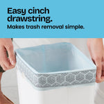 Close-up of hands cinching a light-blue Glad drawstring bag over a square waste bin with 'Easy cinch drawstring' text