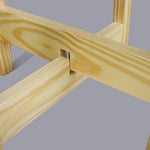 Close-up detail of interlocking pine wood joints on a mid-century style plant stand showing wood grain