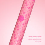 Close-up of patterned pink toothbrush handle with power button and subtle Wicked icons