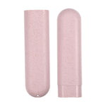 Close-up of two pink speckled toothbrush travel case halves, one showing base hole and the other with cap removed.