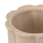 Close crop of a tan scalloped planter rim and interior, revealing speckled textured exterior and smooth inside.