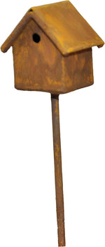 Close-up of a rust-toned miniature metal birdhouse mounted on a slender stake, isolated on white