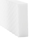 Close-up angled view of a white textured melamine cleaning eraser block on white background