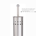 Close-up of a stainless steel vented toilet brush holder with the handle visible and a small descriptive caption