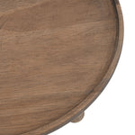Close-up of the rim and surface texture of a round brown wooden plant stand showing grain detail