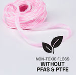 Coiled pink and white expanding floss strand with leaf icon and text declaring non-toxic floss without PFAS & PTFE