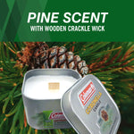 Open Coleman citronella candle tin with visible wooden crackle wick set against pine cones and needles background