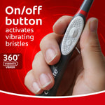 Close-up of a hand holding the Colgate 360 handle showing the on/off buttons with 'activates vibrating bristles' text
