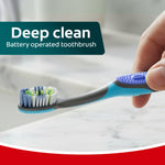 Hand holding a Colgate 360 Vibrate toothbrush at an angle over a bathroom counter with 'Deep clean' text overlay