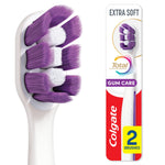 Close-up of a white toothbrush head with dense purple and white bristles next to Colgate gum care packaging showing '2 brushes' badge.