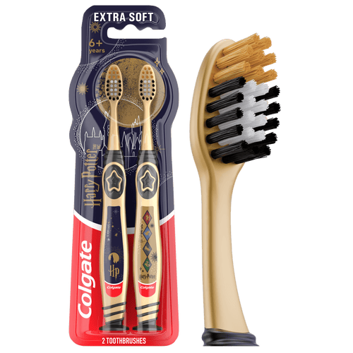 Packaged Colgate Harry Potter kids toothbrushes in gold-themed twin blister pack with branded handles