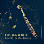 Gold-handled Colgate Harry Potter toothbrush displayed diagonally with starburst accents and text about slim handle