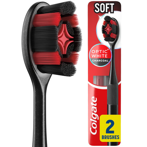 Close-up of a Colgate Optic White Charcoal soft toothbrush head and packaged two-pack with red and black bristles visible
