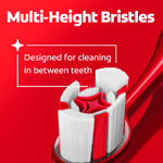 Toothbrush head close-up highlighting multi-height bristles on a red Colgate Optic White brush