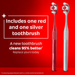 Two Colgate Optic White toothbrushes, one red and one silver, with text noting included colors
