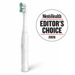 White Colgate sonic battery toothbrush with teal-accent bristles shown upright alongside a Men’s Health Editor’s Choice 2026 badge