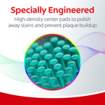 Macro image showing tightly packed teal center pads of Colgate Total toothbrush in a circular magnified inset.