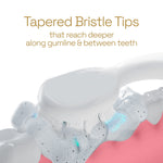 Rendered image of a toothbrush cleaning along teeth with foam, highlighting tapered bristle tips that reach along the gumline