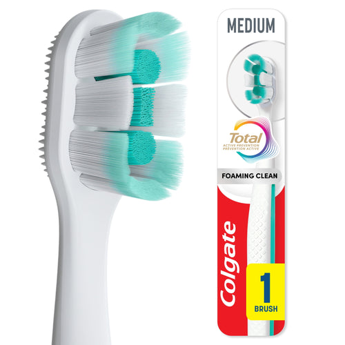Close-up of a Colgate Total toothbrush head and partial packaged handle, showing dense turquoise and white bristles
