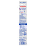 Back of Colgate travel toothbrush package with usage illustrations, multilingual text and product information panel