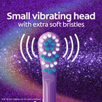Close-up of a small vibrating purple toothbrush head with extra soft bristles shown against a sparkly purple background.